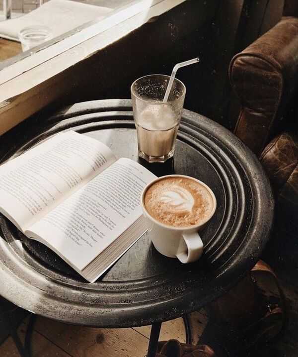 كتاب مفتوح مع مشروب دافئ في مساحة هادئة